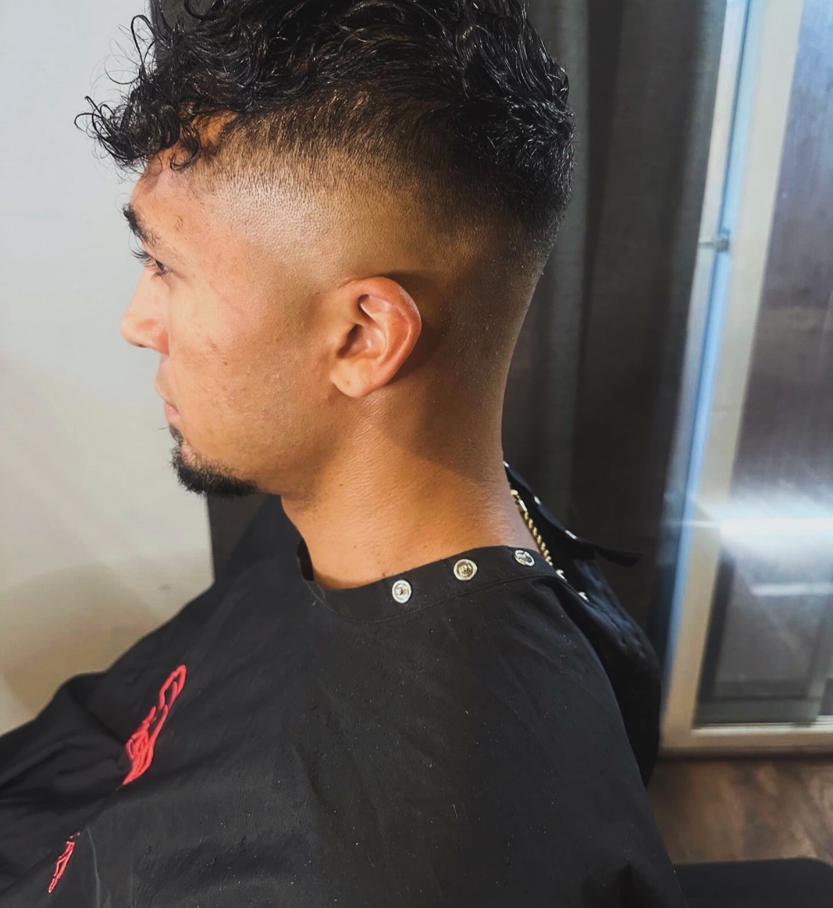 Curly top with high skin fade